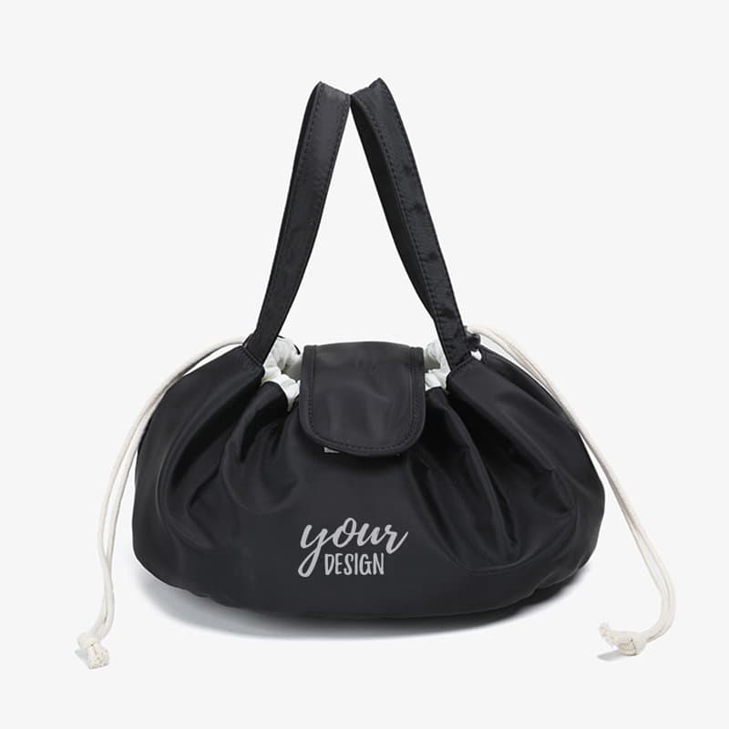 A large black drawstring makeup bag with two handles and a flap closure, featuring a logo. Large Drawstring Makeup Bag - Image 1