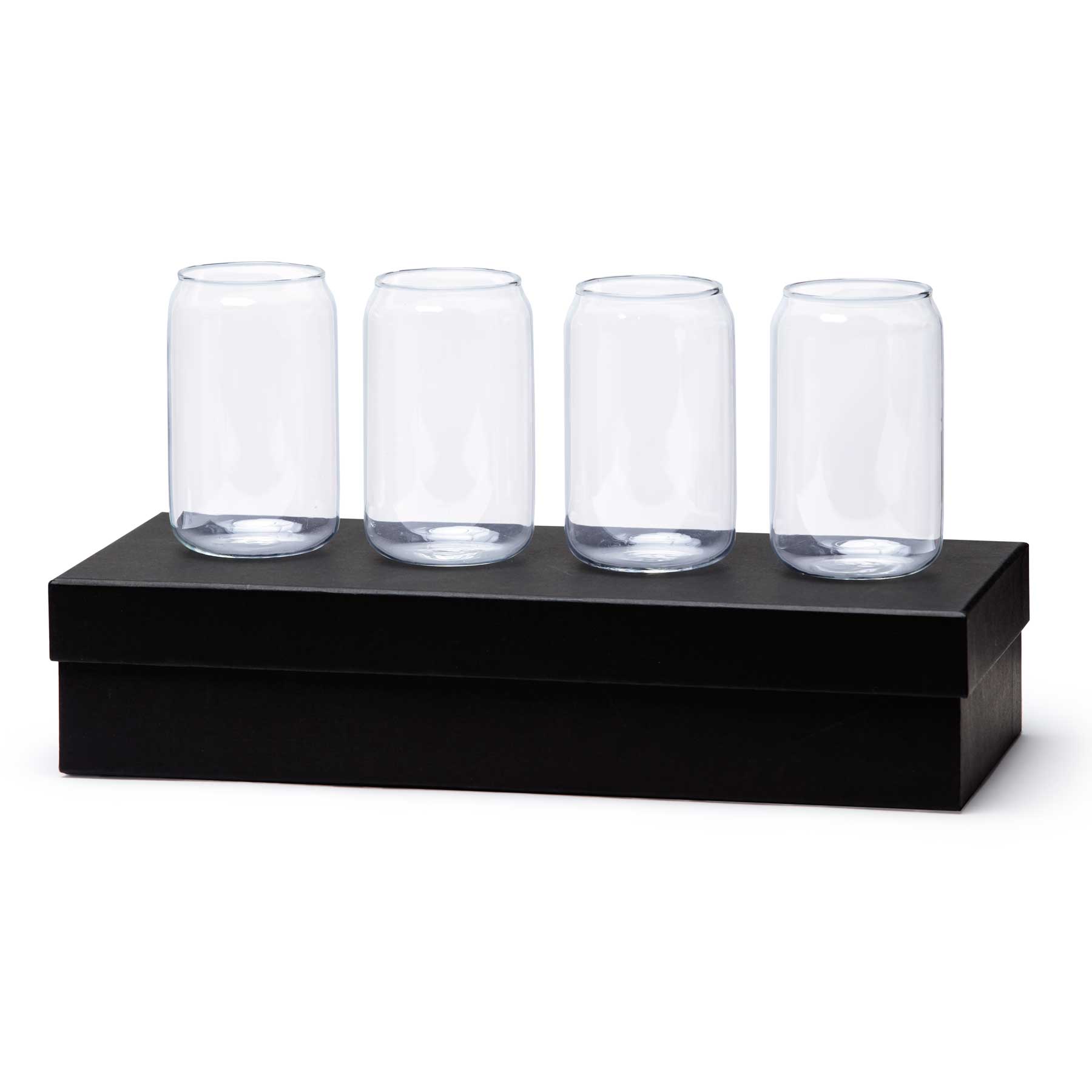 A set of four clear glass beer cans displayed on a black box. The glasses have a cylindrical shape. Beer Can Glass Set - Image 1