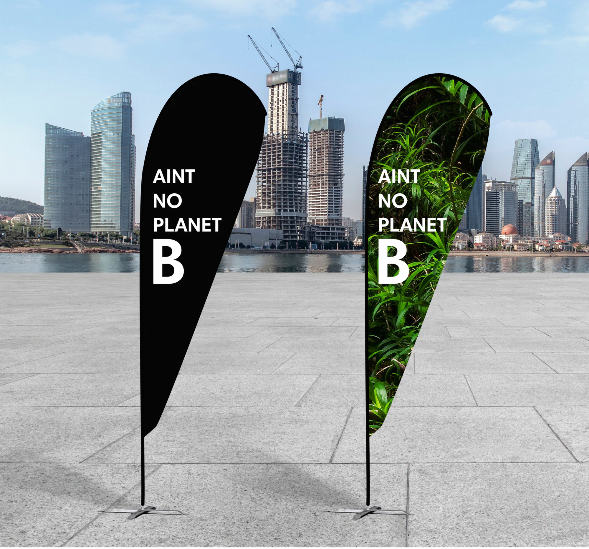 Two large teardrop banners featuring a black side with text and a green nature-themed side, set against an urban backdrop. rPET Teardrop Banner - Large - Image 1