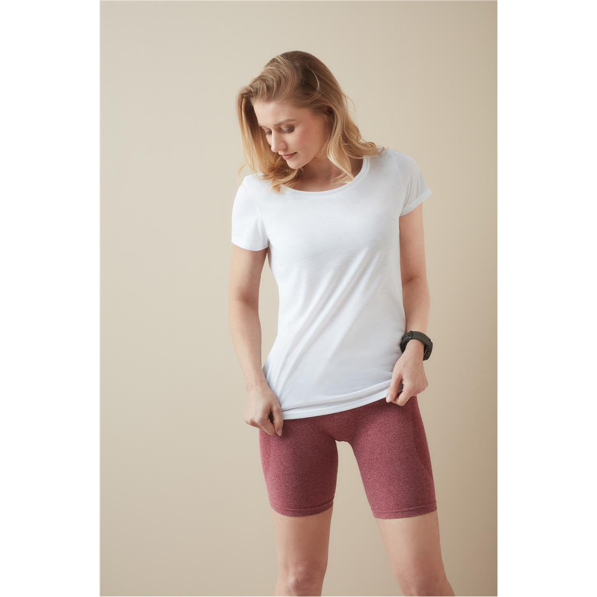 A woman wearing a white T-shirt paired with maroon shorts, featuring a logo on the T-shirt. Women's Active Cotton Touch - Image 1