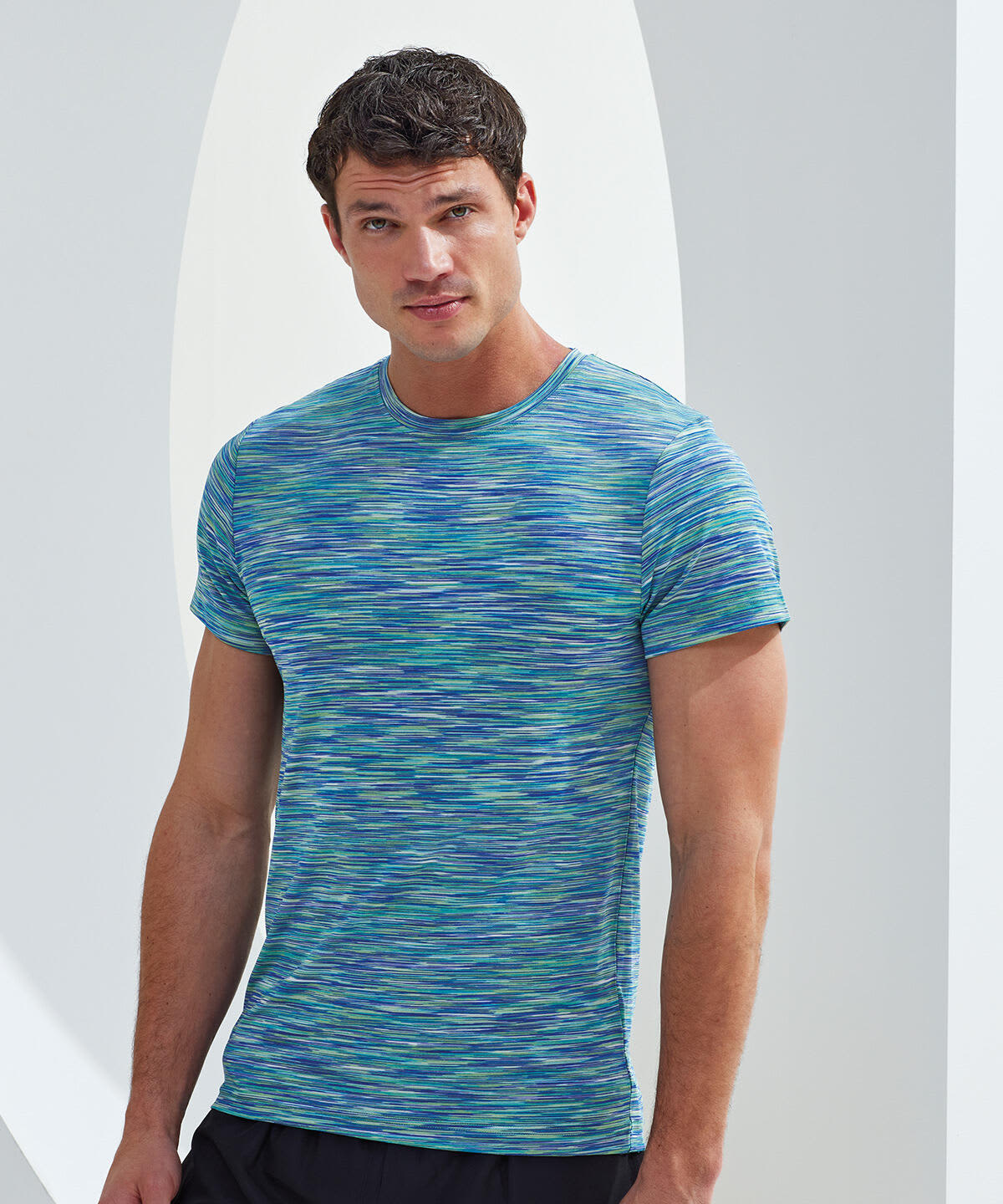 A performance t-shirt in shades of blue and green with a space dye pattern, featuring a logo on the front. Space Dye Performance T-Shirt - Image 1