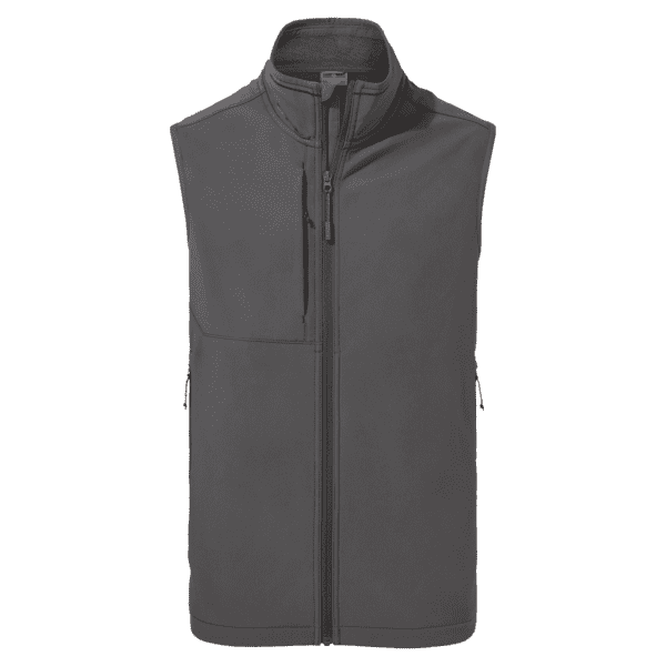 A softshell vest in dark grey, featuring a front zip and one chest pocket, with branding on the fabric. Basecamp Softshell Vest - Image 1