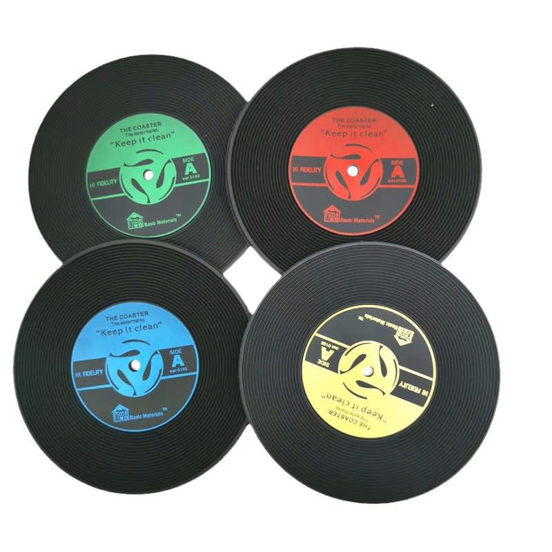 Four round coasters resembling vintage vinyl records in black, red, blue, and green, each featuring a circular logo. Vintage Record Coaster - Image 1
