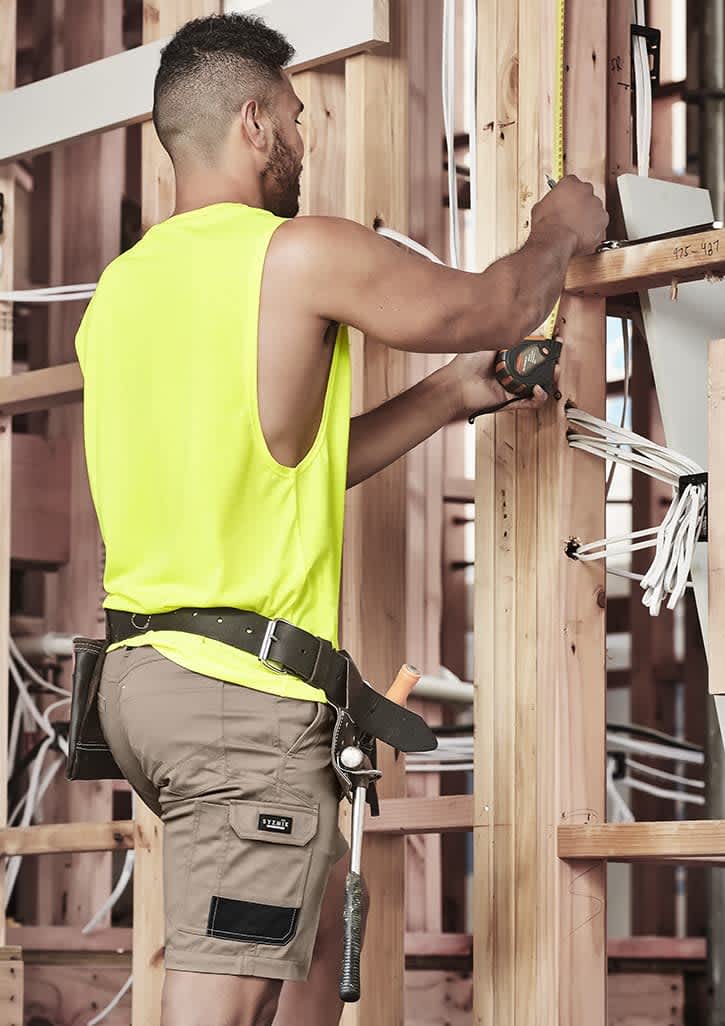 Men's summer cargo shorts in khaki, featuring multiple pockets, worn by a person in a bright yellow sleeveless top. Mens Summer Cargo Short - Image 1