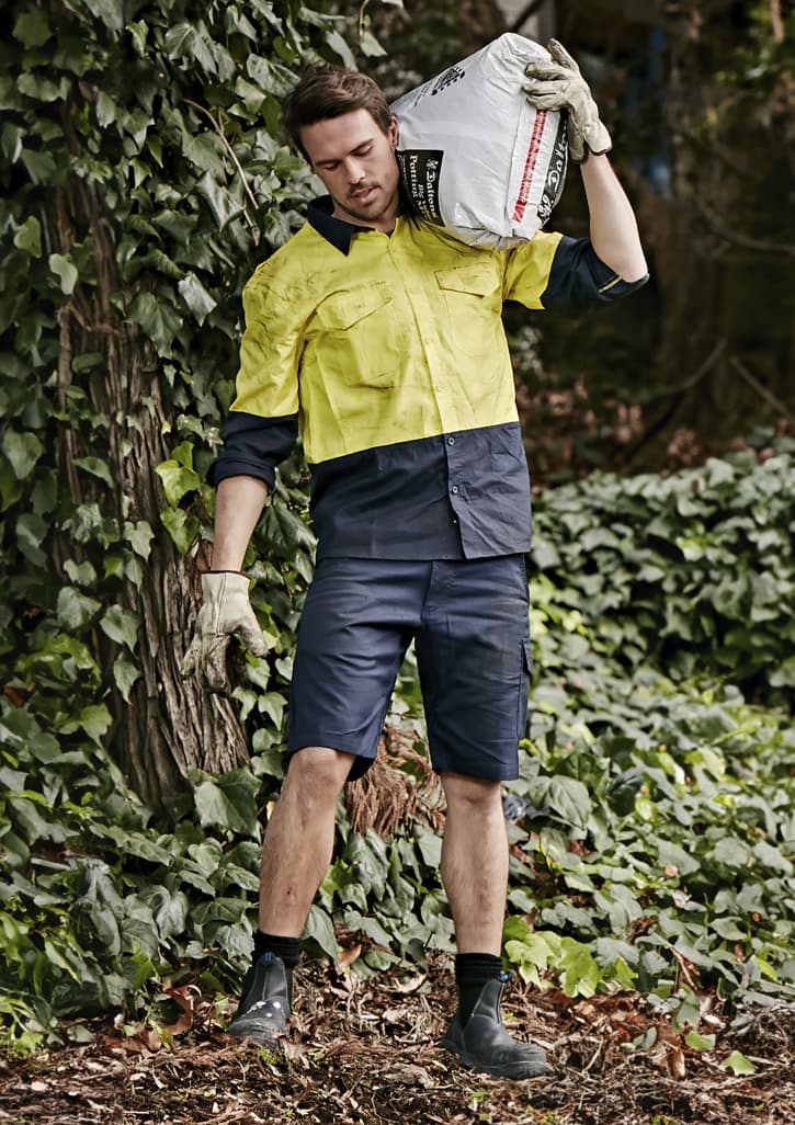 Men's rugged cooling vented shorts in navy, styled with a bright yellow shirt, set against a leafy background. Mens Rugged Cooling Vented Short - Image 1