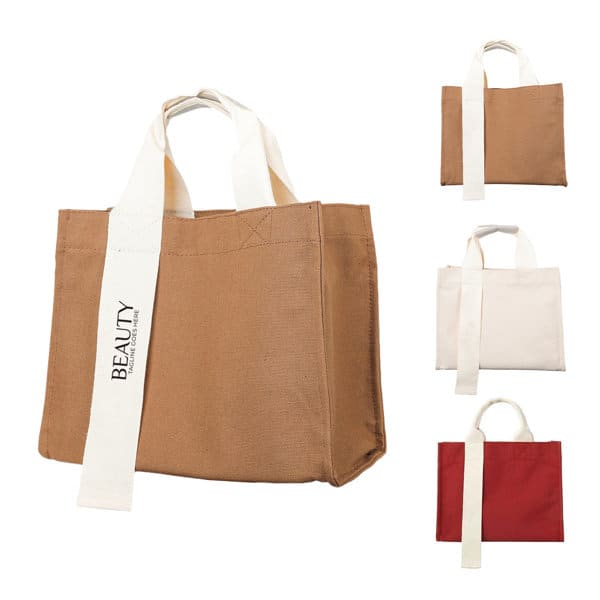 A canvas horizontal shoulder tote bag in brown, with white handles and a logo. Additional bags in white and red are visible. Canvas Horizontal Shoulder Tote Bag - Image 1