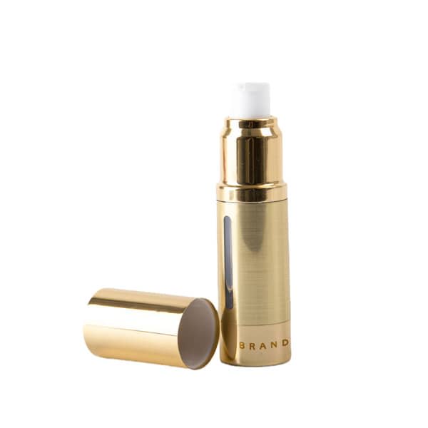 A gold airless pump bottle with a removable cap. It features a sleek, metallic finish and has a logo. 15ml AS Gold Airless Pump Bottle - Image 1