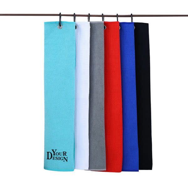 A collection of waffle golf towels in various colours including red, blue, grey, black, white, and aqua, with clips attached. Waffle Golf Towel With Clip - Image 1