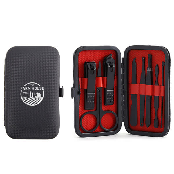 A black manicure set with red interior, containing nail clippers, scissors, tweezers, and grooming tools, in a zippered case. 8 In 1 Nail Clipper Manicure Set - Image 1