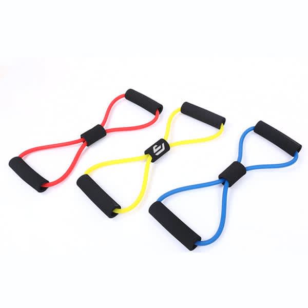 An 8-shaped elastic chest expander in red, yellow, and blue with black foam grips. It features a logo in the centre. 8 Shaped Elastic Chest Expander - Image 1