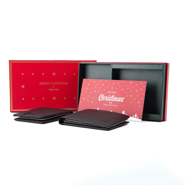 A black wallet gift set in a red and black box, accompanied by a Christmas greeting card. Customizable Wallet Gift Box And Greeting Card Set - Image 1