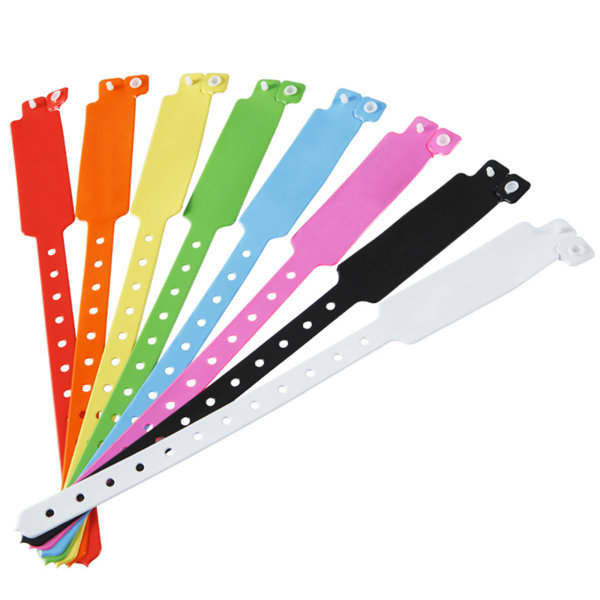 A collection of PVC custom adjustable wristbands in various colours including red, orange, yellow, green, pink, black, and white. PVC Custom Adjustable Wrist Band - Image 1