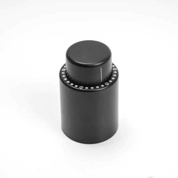 A black wine stopper featuring a time scale, with a smooth rounded top and a circular base. Wine Stopper With Time Scale - Image 1