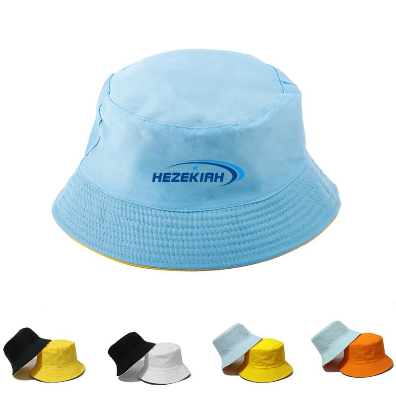 A light blue reversible bucket hat with a logo, displayed alongside hats in black, white, yellow, and teal. Solid Reversible Travel Bucket Hat - Image 1