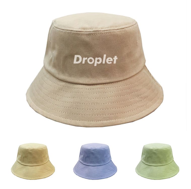 A unisex lightweight bucket hat in beige, featuring a logo and accompanied by green, yellow, and blue variations. Unisex Cotton Trendy Lightweight Bucket Hat - Image 1