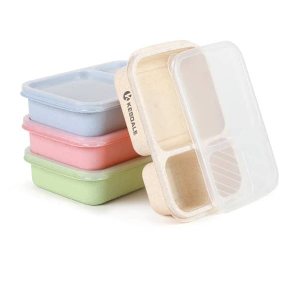 A stack of four 3-compartment bento lunch boxes in pink, green, blue, and a natural colour, with a transparent lid and a logo. 3 Compartment Reusable Wheat Straw Bento Lunch Box - Image 1