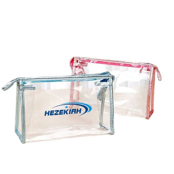 Clear PVC travel zipper cosmetic bags in pink and silver, featuring a logo on the front of each bag. Clear PVC Travel Zipper Cosmetic Bag - Image 1