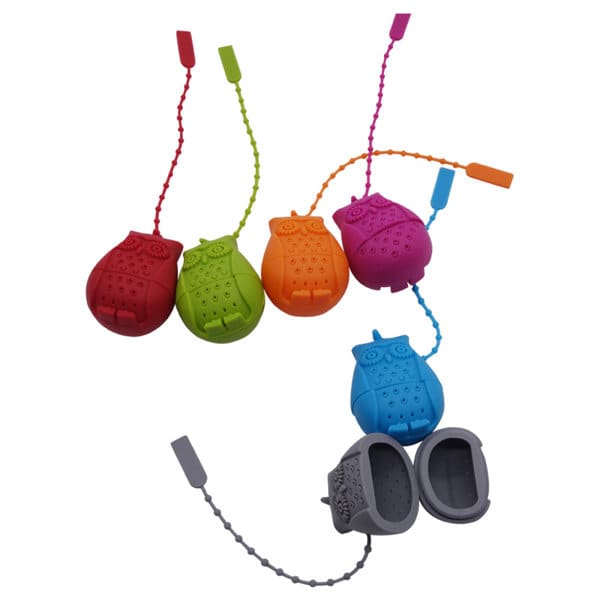 A set of colourful owl-shaped silicone tea infusers in red, green, purple, and blue. Each infuser has a chain for easy removal. Owl Silicone Tea Infuser - Image 1