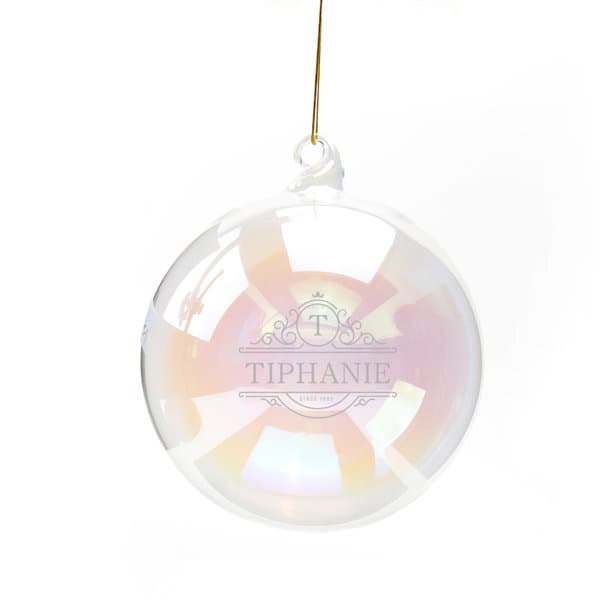A clear glass ball featuring an iridescent finish and a hanging attachment, with a logo and branding. 12cm Clear Hanging Glass Ball - Image 1
