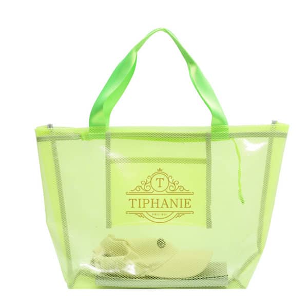A clear PVC tote bag in neon green with matching handles and a white hat inside. It has a logo on the front. PVC Clear Tote Bag - Image 1