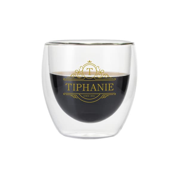 A double wall glass cup with a clear exterior and a dark beverage inside, featuring a logo design. 8 oz. Double Wall Glasses Cup - Image 1
