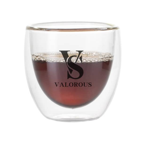 A transparent double-layer glass coffee cup containing a dark drink, featuring a logo on the front. 3 oz. Transparent Double-layer Glass Coffee Cup - Image 1