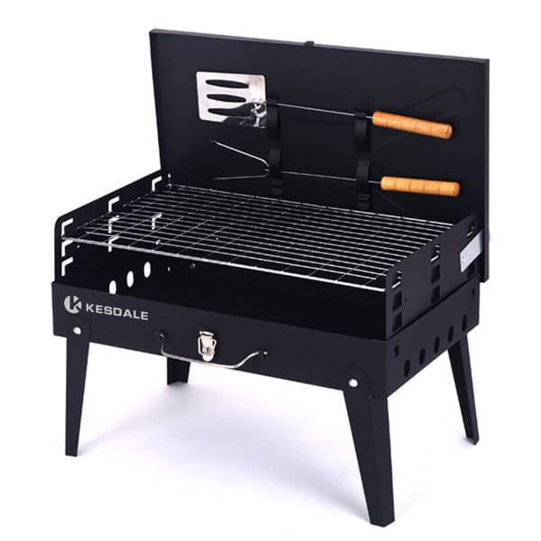 A black outdoor barbecue grill with a tool set, featuring a grill rack and wooden-handled utensils. It has a lid and legs. Outdoor Barbecue Grill With Tool Set - Image 1