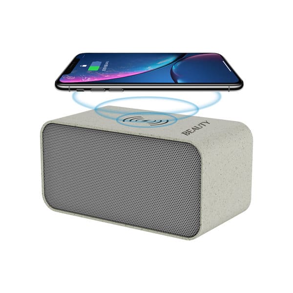 A portable wireless speaker in grey with a phone placed above for wireless charging. Features a logo on the side. 5W Portable Wireless Speaker - Image 1