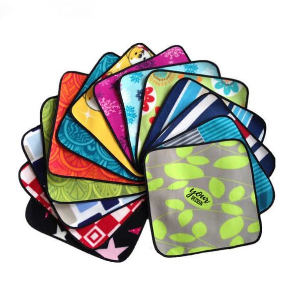 A collection of vibrant picnic seat mats in various patterns and colours, featuring multiple designs. Each mat has a logo. Single Picnic Seat Mat - Image 1