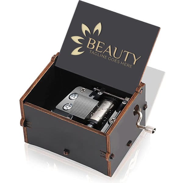 A wooden music box with a hand crank, featuring a dark exterior and decorative lid with a logo. Halloween Hand Crank Wooden Music Box - Image 1