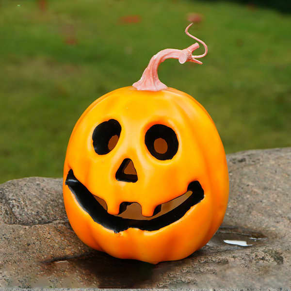 A bright orange pumpkin with a ghost face, featuring black eyes, a smiling mouth, and a pink stem. Halloween Artificial Ghost Face Pumpkin - Image 1