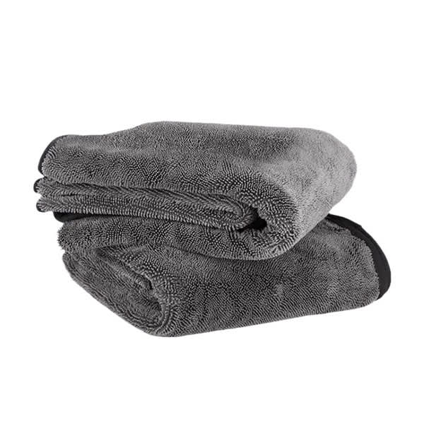 A grey twist car drying towel folded, featuring a textured surface and a black trim. It includes a branding logo. Twist Car Drying Towel - Image 1