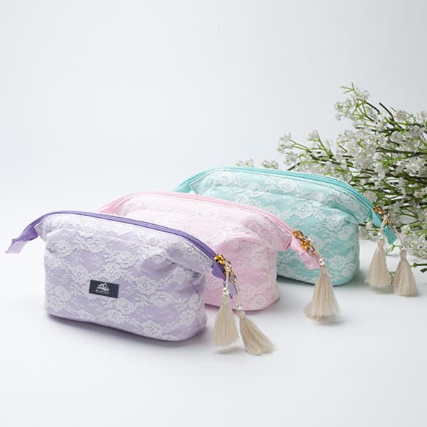 A lace cosmetic bag set in lavender, pink, and mint green, featuring tassel zippers and a logo. Lace Cosmetic Bag With Tassel Zipper - Image 1