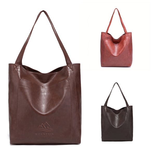 A soft PU leather handbag in brown, red, and dark brown, featuring long handles and a subtle logo design. Soft PU Leather Handbag - Image 1