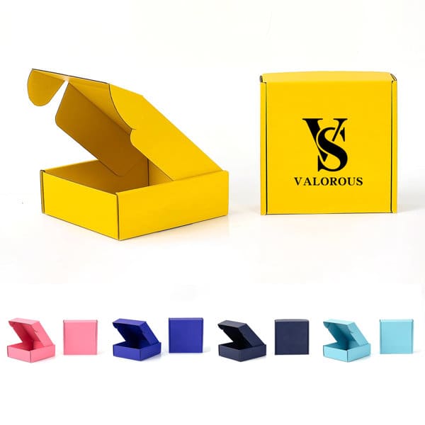 A yellow custom corrugated mailing box with an open flap and a logo, alongside various coloured boxes in shades of pink, blue, and teal. Custom Corrugated Mailing Box - Image 1