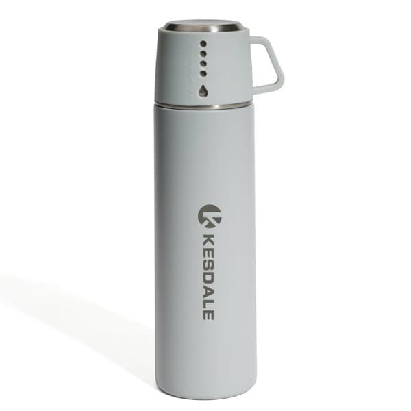 A drink bottle in light grey with a cup attached and a logo on the side, designed for insulation and durability. 17 oz. Stainless Steel Insulated Bottle With Cup - Image 1