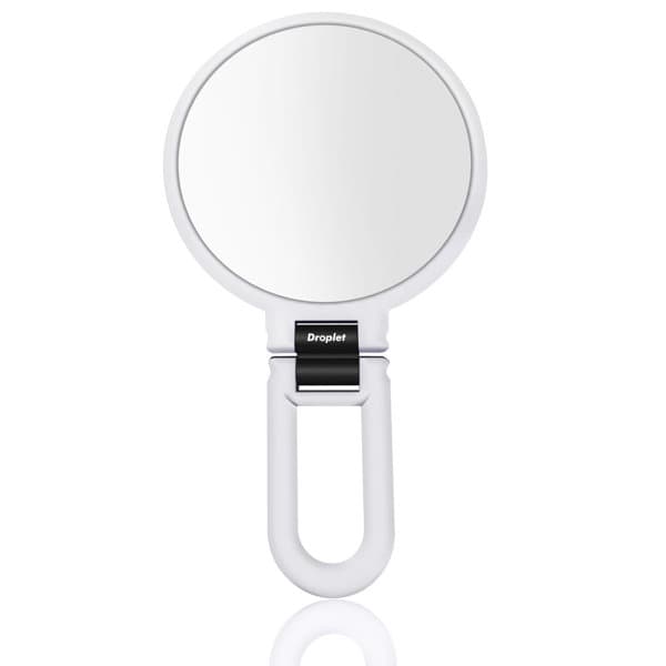 A white handheld magnifying makeup mirror with a circular reflective surface and a sleek handle. The product features a branding logo. Magnifying Handheld Makeup Mirror - Image 1