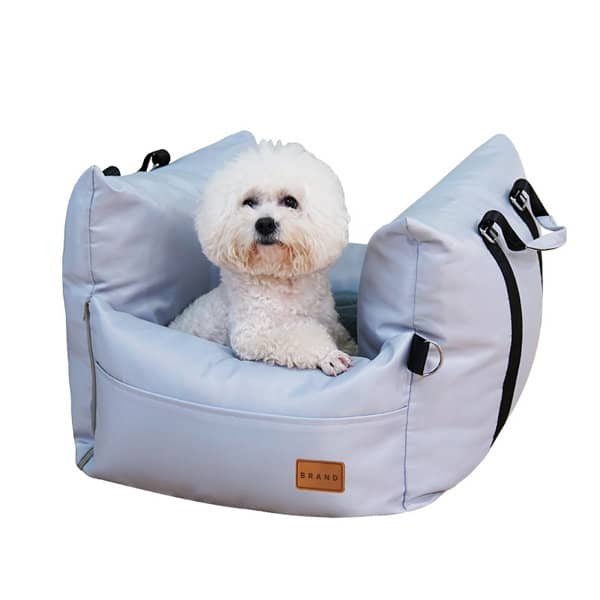 A light blue dog car seat with a plush interior, featuring a small white dog comfortably seated inside. Dog Car Seat - Image 1