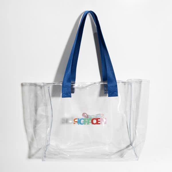 A large transparent tote bag with blue handles and a branded logo in various colours. Large Transparent Tote Bag - Image 1