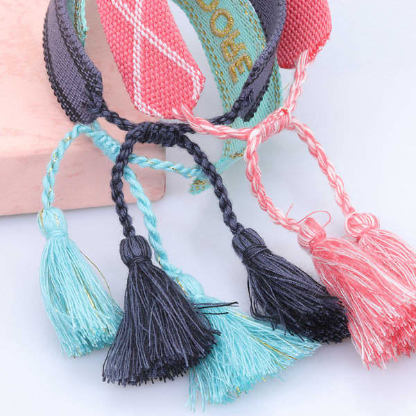 A collection of adjustable women's bracelets featuring colourful embroidery and decorative tassels in blue, black, and pink. Adjustable Embroidery Tassel Women Bracelet - Image 1
