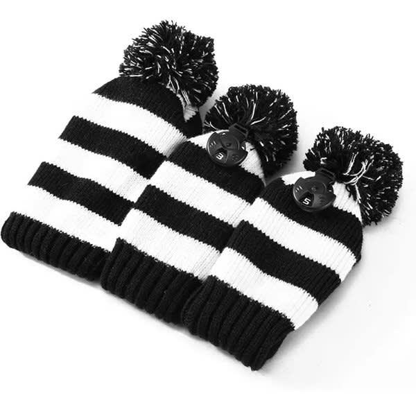 A knitted golf club head cover set in black and white stripes, featuring pom-poms on top. Comes with three sizes. Knitted Golf Club Head Cover Set With Pom - Image 1