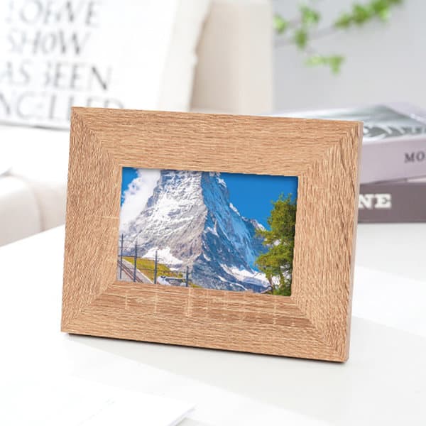 A wooden picture frame in a light tan colour, displaying a scenic mountain photograph. Personalized Picture Frames - Image 1