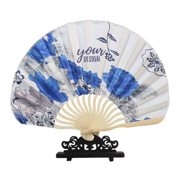 A folding hand fan featuring a colourful floral design in blue and white, with a decorative black stand. Custom Printed Folding Hand Fan - Image 1