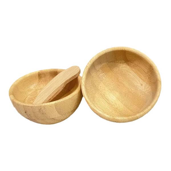 Two bamboo mixing bowls in natural colour, one with a wooden spatula resting inside. Contains a logo. DIY Bamboo Facemask Mixing Kit - Image 1