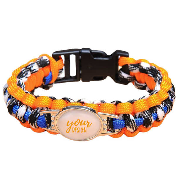 A custom woven paracord bracelet featuring orange, black, and blue colours with a logo space for personalised design. Custom Woven Paracord Bracelet - Image 1