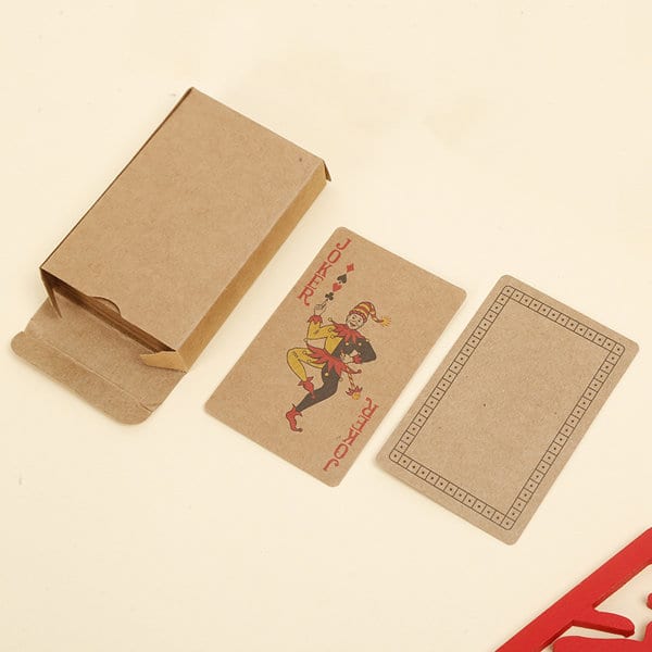 A pack of kraft paper playing cards with a jester design, displayed alongside its kraft paper box. Promotional Kraft Paper Playing Cards - Image 1