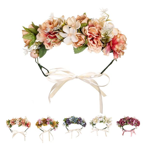A floral headband featuring delicate pink, peach, and white flowers with green leaves and a ribbon tie. Adjustable Flower Wreath Headband - Image 1