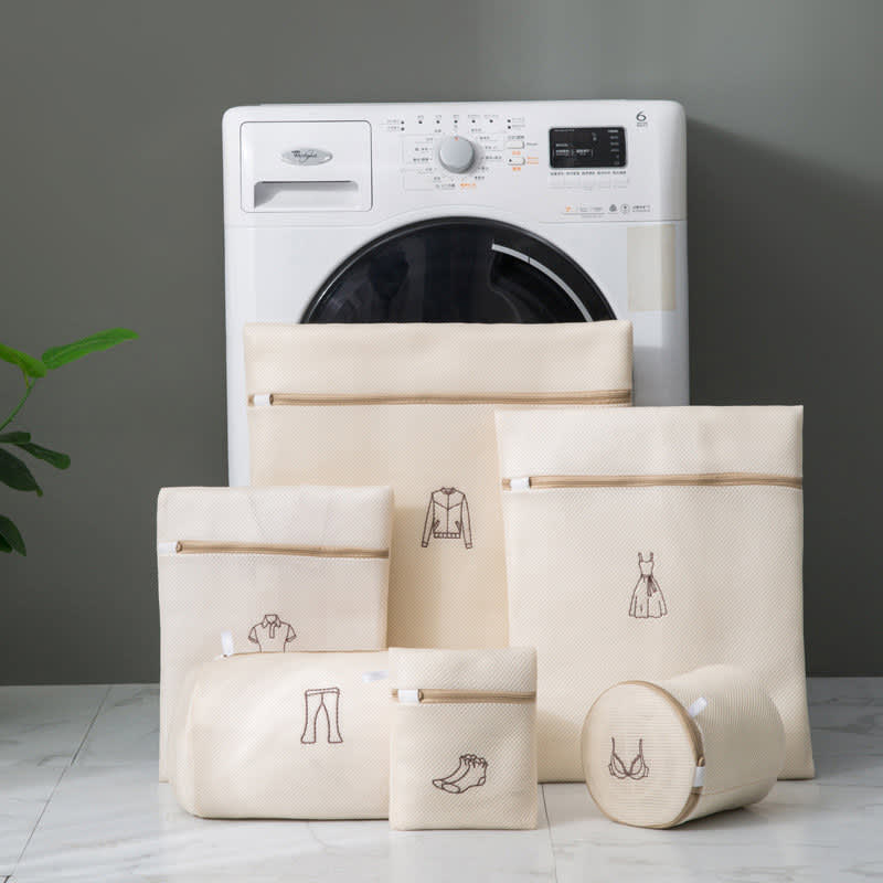 A set of six double-layer mesh laundry bags in cream, featuring various sizes and detailed illustrations on each bag. 6 Pcs Double Layer Mesh Laundry Bag Set - Image 1