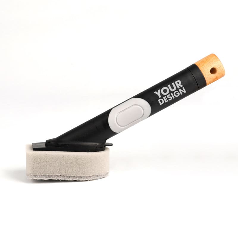 A soap sponge brush with a black handle and a wooden accent, featuring a grey sponge head. It has a logo. Soap Sponge Brush With Handle - Image 1
