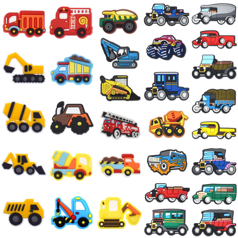 A collection of colourful PVC ornaments shaped like various vehicles, including trucks, cars, and construction machinery. Pvc Shoes Pins Ornaments - Image 1